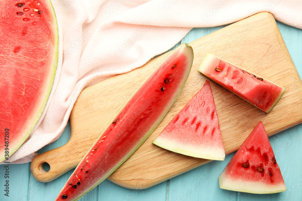 Yummy cut watermelon on light blue wooden table, flat lay Yummy cut watermelon on light blue wooden table, flat lay