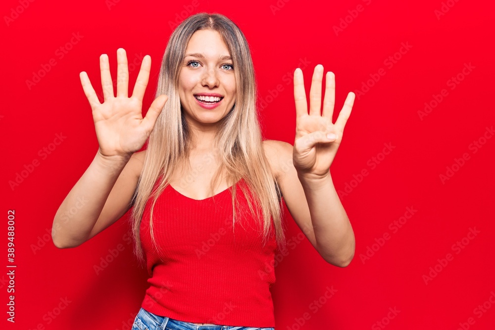Young blonde woman wearing casual clothes showing and pointing up with fingers number nine while smiling confident and happy. Young blonde woman wearing casual clothes showing and pointing up with fingers number nine while smiling confident and happy.