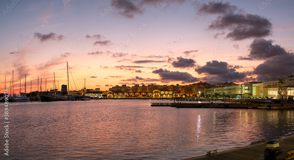 Sunset at the port of Valencia harbor, water reflection marina port nautical scene