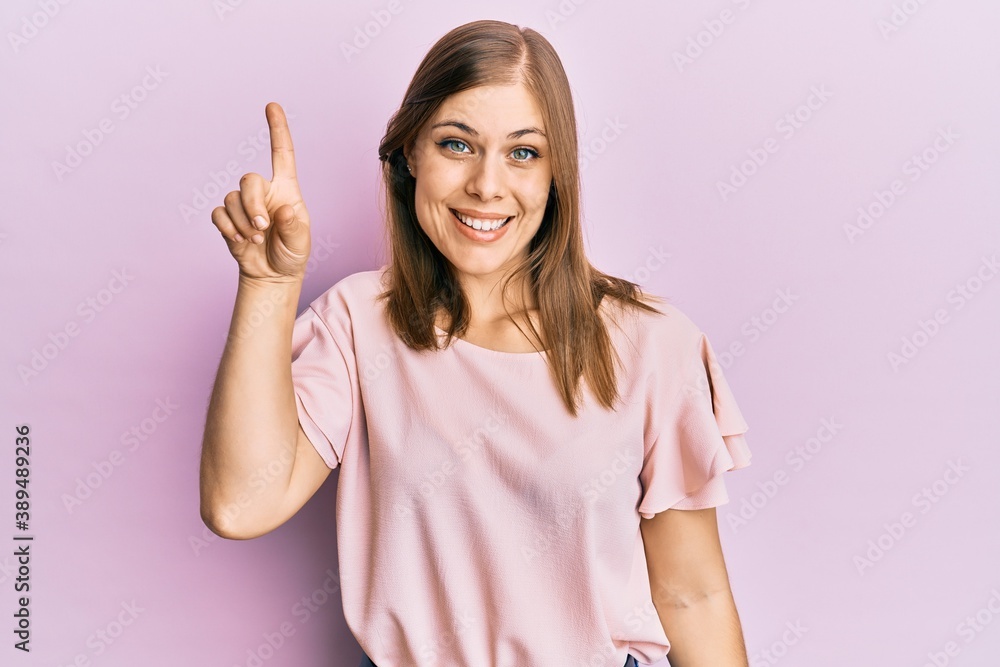 Beautiful caucasian woman wearing casual clothes smiling with an idea or question pointing finger up with happy face, number one Beautiful caucasian woman wearing casual clothes smiling with an idea or question pointing finger up with happy face, number one