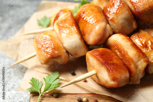 Delicious chicken shish kebabs with parsley on grey background, closeup