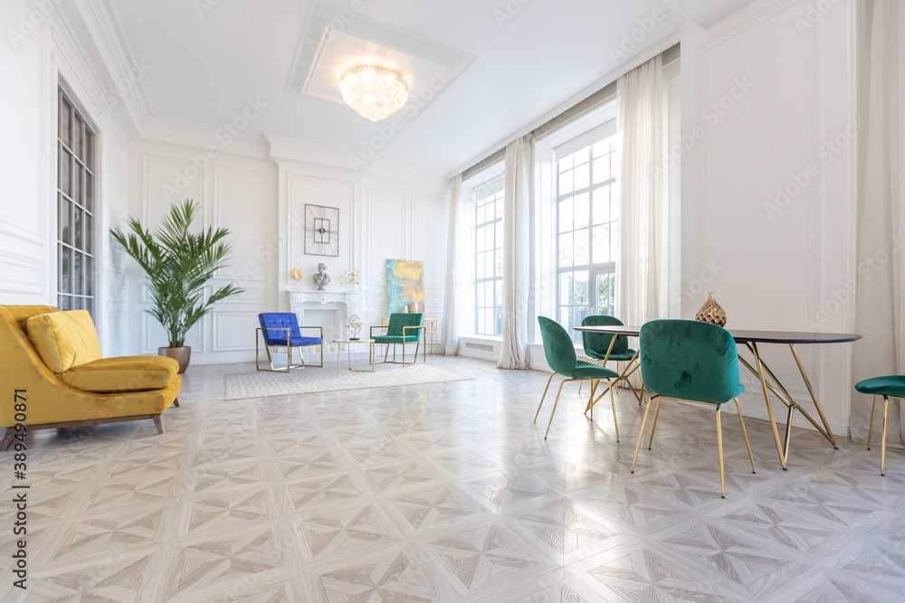 Fototapeta premium modern and very stylish interior design of large studio apartment with fashionable furniture with gold elements. very light and bright room with big windows
