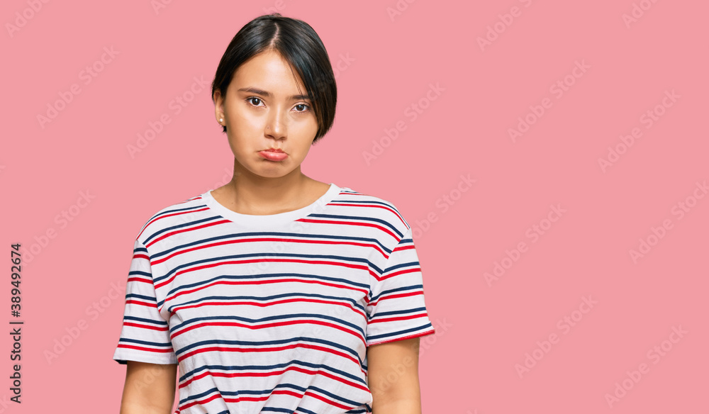 Beautiful young woman with short hair wearing casual clothes depressed and worry for distress, crying angry and afraid. sad expression. Beautiful young woman with short hair wearing casual clothes depressed and worry for distress, crying angry and afraid. sad expression.