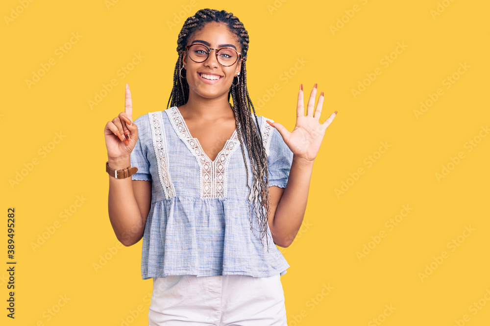 Young african american woman with braids wearing casual summer clothes and glasses showing and pointing up with fingers number six while smiling confident and happy. Young african american woman with braids wearing casual summer clothes and glasses showing and pointing up with fingers number six while smiling confident and happy.