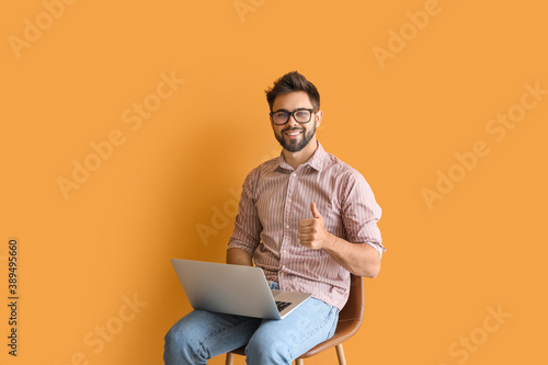 Man with laptop studying on...
