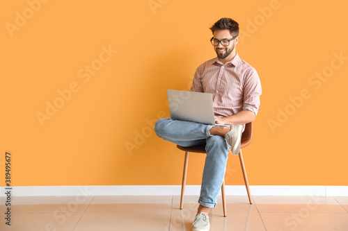 Man with laptop studying on...