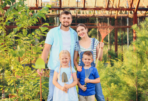 Happy young family in green...