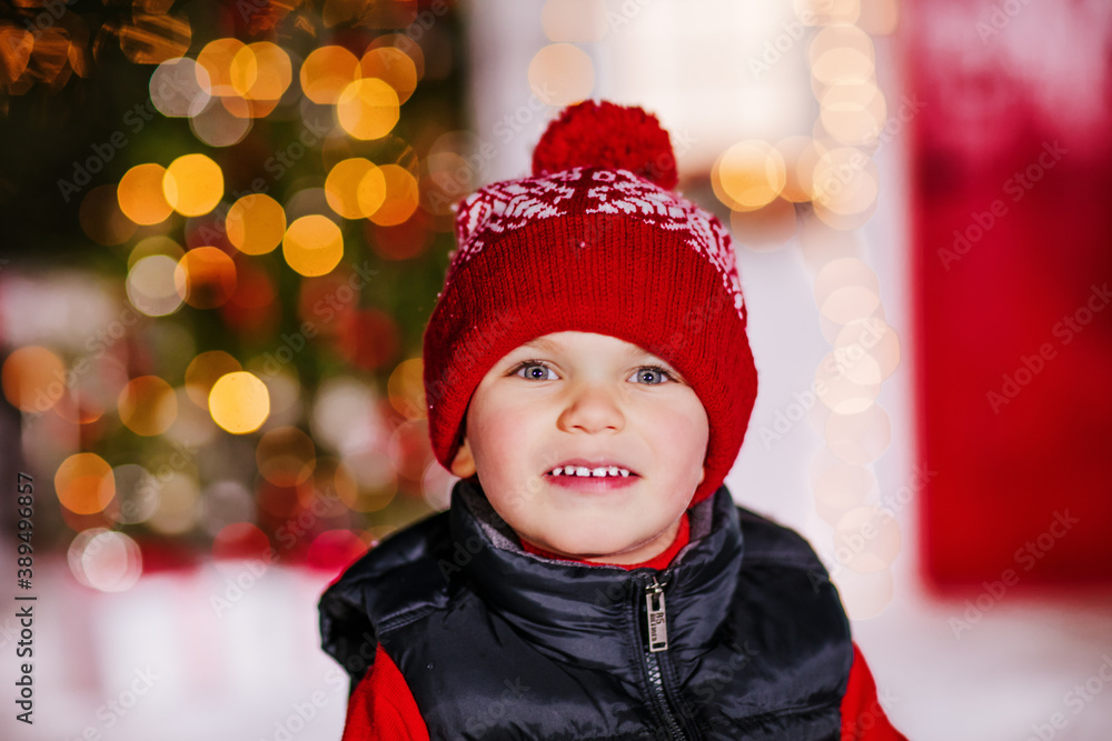 portrait of little boy in rad hat on Christmas background portrait of little boy in rad hat on Christmas background