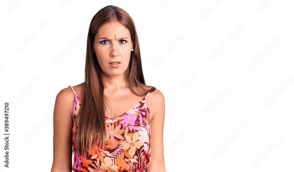 Young beautiful hispanic woman wearing casual clothes in shock face, looking skeptical and sarcastic, surprised with open mouth Young beautiful hispanic woman wearing casual clothes in shock face, looking skeptical and sarcastic, surprised with open mouth