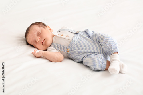 Cute little baby lying on bed
