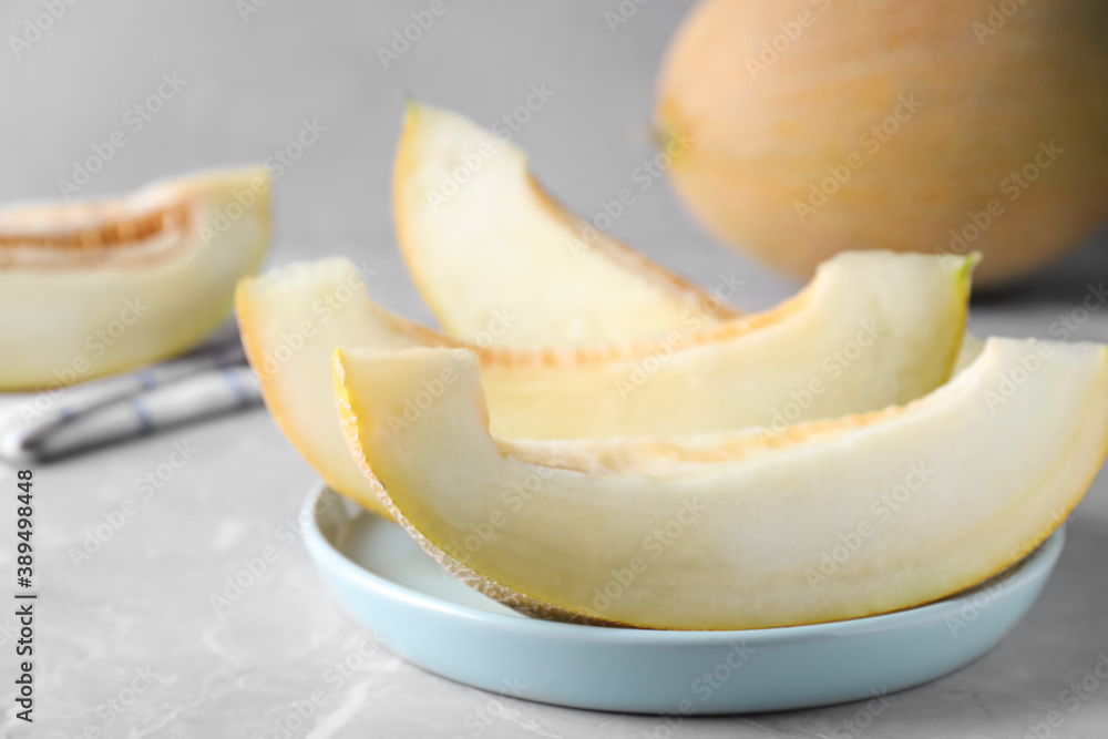 Pieces of delicious honeydew melon on light grey marble table Pieces of delicious honeydew melon on light grey marble table