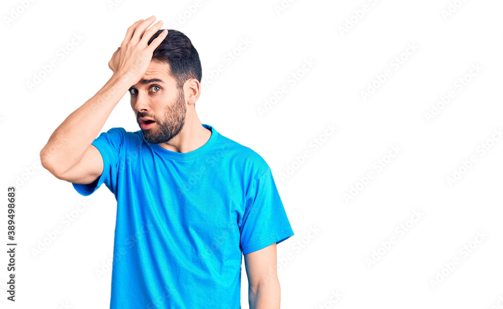 Young handsome man with beard wearing casual t-shirt surprised with hand on head for mistake, remember error. forgot, bad memory concept. Young handsome man with beard wearing casual t-shirt surprised with hand on head for mistake, remember error. forgot, bad memory concept.