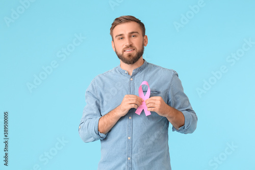 Man with pink ribbon on col...