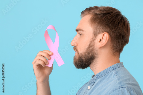 Man with pink ribbon on col...