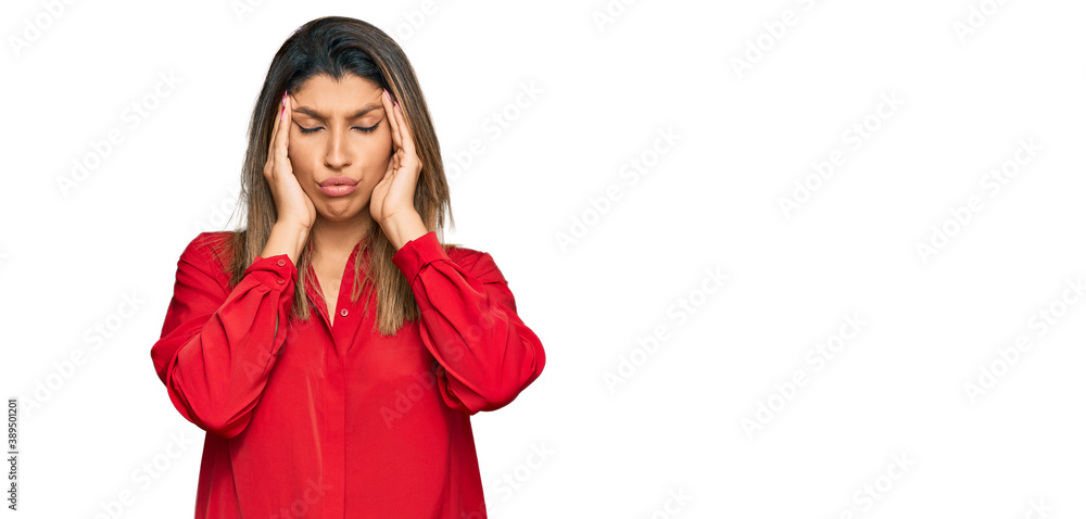 Beautiful brunette woman wearing casual clothes suffering from headache desperate and stressed because pain and migraine. hands on head.