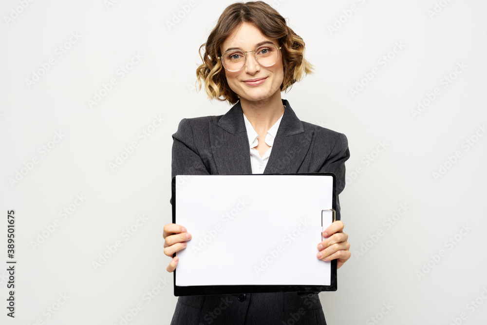 Business woman with a folder of documents on a light background cropped view and shirt suit Business woman with a folder of documents on a light background cropped view and shirt suit