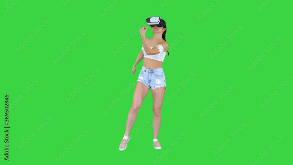 Cute girl dancing while she has her VR on Dancing time on a Green Screen, Chroma Key. Cute girl dancing while she has her VR on Dancing time on a Green Screen, Chroma Key.