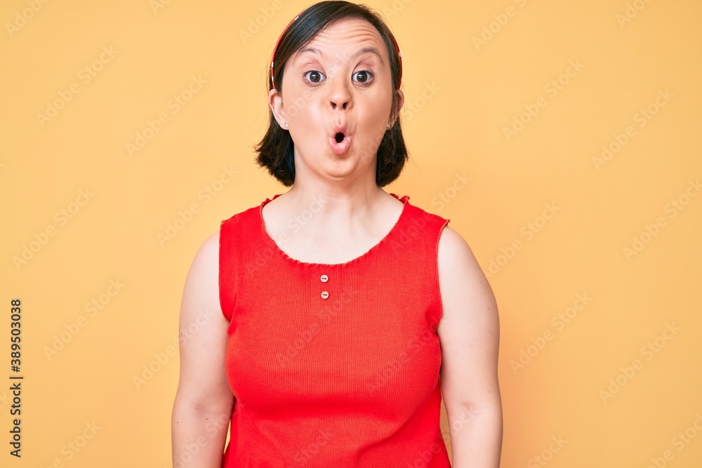 Brunette woman with down syndrome wearing casual clothes scared and amazed with open mouth for surprise, disbelief face Brunette woman with down syndrome wearing casual clothes scared and amazed with open mouth for surprise, disbelief face