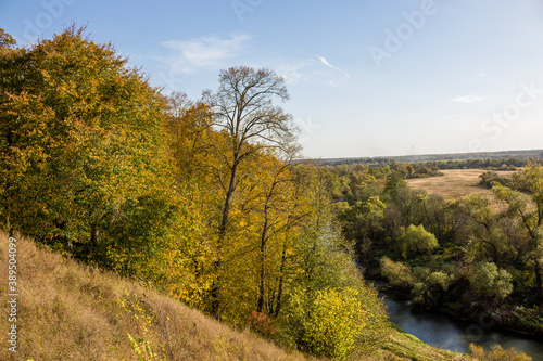 Fototapeta Naklejka Na Ścianę i Meble -  Nice view of the slope and valley of the Luzha river. View from the village Dubrovka, Maloyaroslavets district, Kaluzhskiy region, Russia. Autumn landscape of central Russia