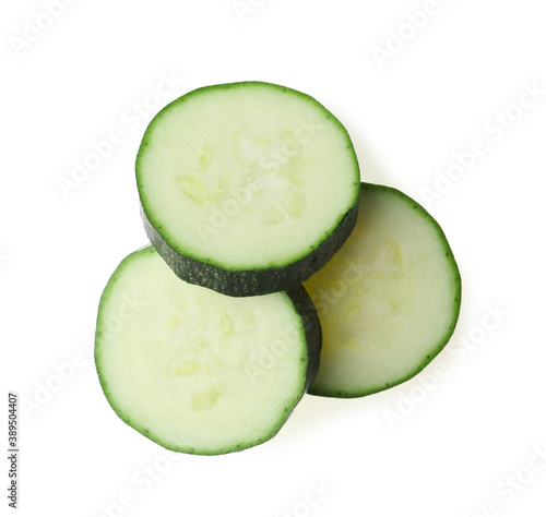 Slices of ripe zucchini on white background, top view