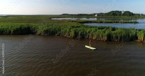 Young woman paddle boarding on the sound in the Other Banks, North Carolina, Aerial Drone Shot