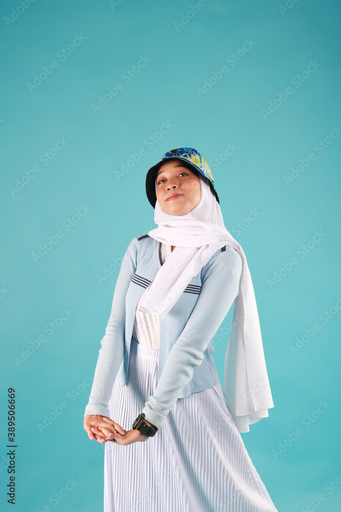 Fashion portrait of young beautiful asian muslim woman with wearing hijab on blue background. Fashion portrait of young beautiful asian muslim woman with wearing hijab on blue background.