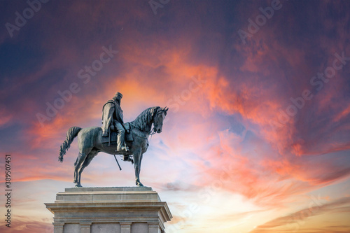 Monument to Garibaldi statue of Giuseppe Garibaldi an italian general riding a horse in bronze in italy rome. Dramatic pink skies.