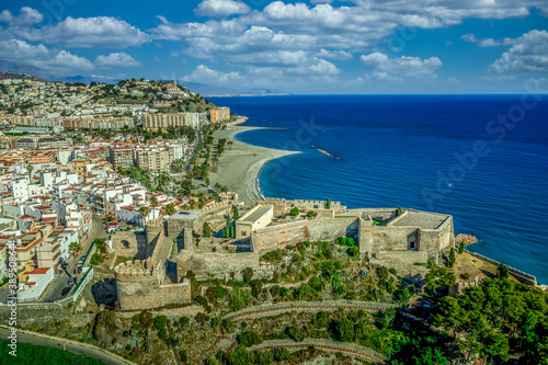 Almunecar on Spain's south coast, known for beaches like Velilla, San Cristobal and Del Mar. Aerial view of is a centuries-old Arab fort San Miguel Castle. The Rocks of San Cristobal extends to sea