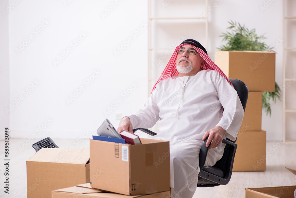 Old arab businessman in office relocation concept Old arab businessman in office relocation concept