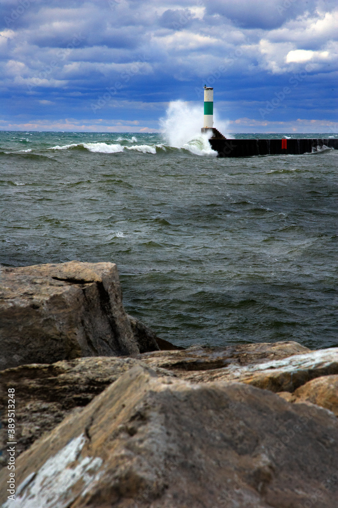 Waves crashing the shoreline, sea wall and giant rocks of Lake Superior
