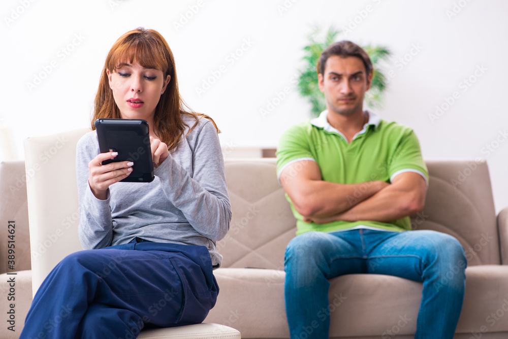 Young couple in gadget dependency concept Young couple in gadget dependency concept