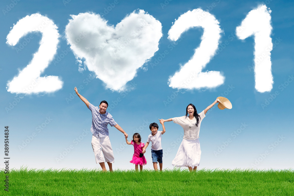 Happy family running with clouds shaped number 2021 Happy family running with clouds shaped number 2021
