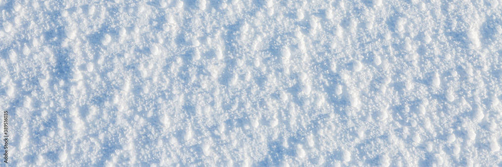 Natural snow texture. The surface of an icy snow crust. Snowy ground. Winter background with snow patterns. Perfect for Christmas and New Year design. Closeup top view.