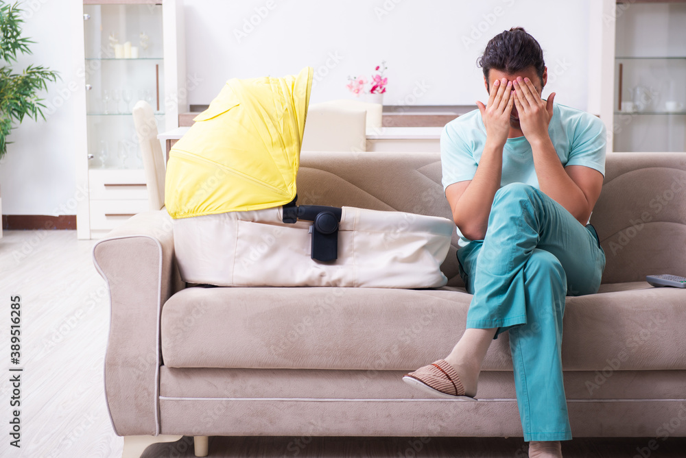 Young male parent looking after newborn at home Young male parent looking after newborn at home