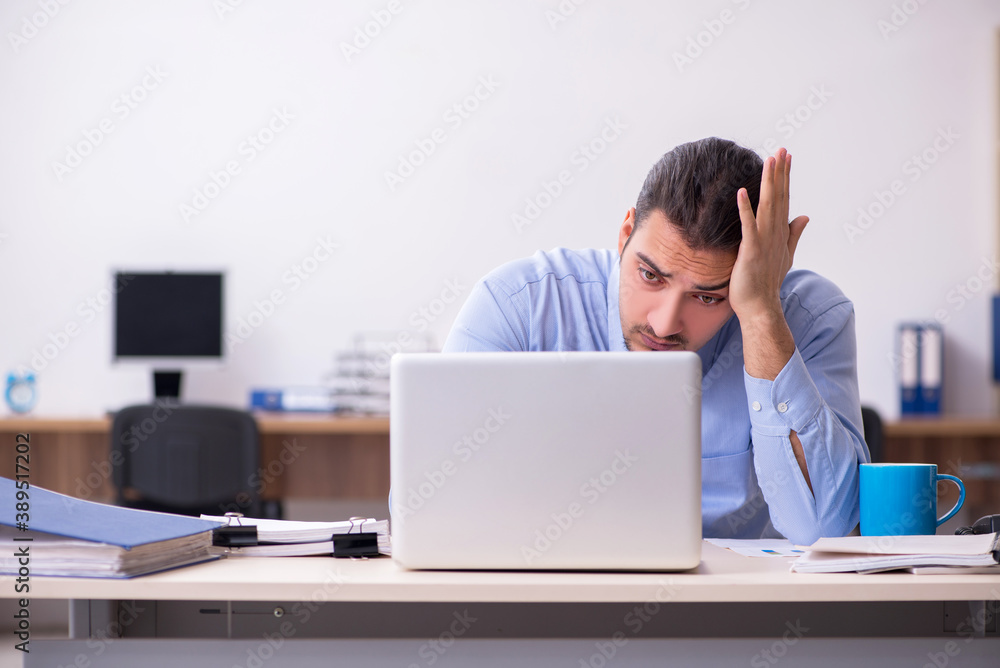 Sick male employee suffering at workplace Sick male employee suffering at workplace