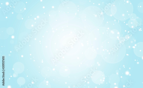 White glitter vintage lights on soft blue background. Bokeh silver and white. defocused  Celebration  Christmas Holiday background.