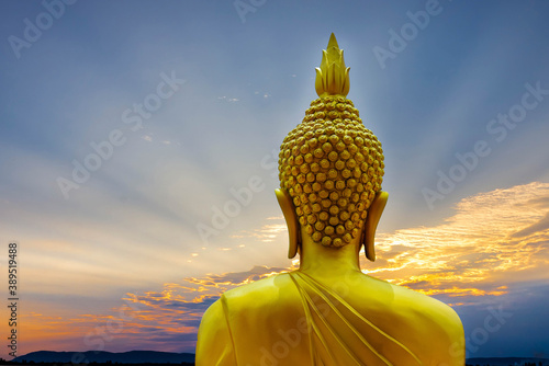 Buddha Status on the mountain with sunset sky background.