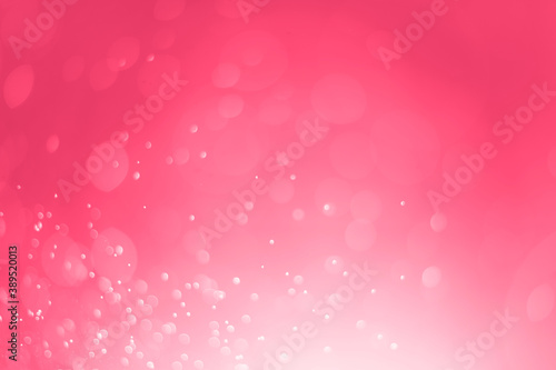 Pink glitter lights abstract background. Defocused white bokeh on pink background.
