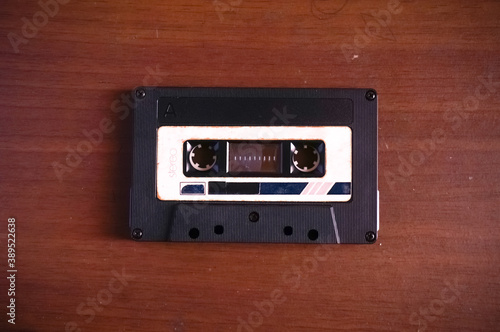 Audio cassette tape on wood background 