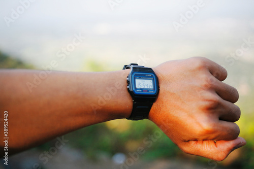 close up hand showing wristwatch  photo