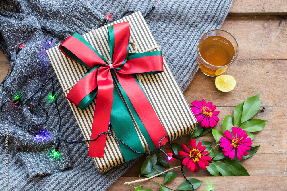 gift box for special in christmas and happy new year festival day with sweater knitting wool of lifestyle woman in winter season and hot lemon tea for health care on background wooden gift box for special in christmas and happy new year festival day with sweater knitting wool of lifestyle woman in winter season and hot lemon tea for health care on background wooden