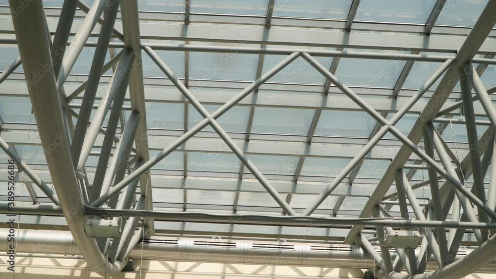 Roof of moden buildings. Abstract high-tech architecture background, internal metal frame structure of glass roof arch with lockable windows sections Roof of moden buildings. Abstract high-tech architecture background, internal metal frame structure of glass roof arch with lockable windows sections