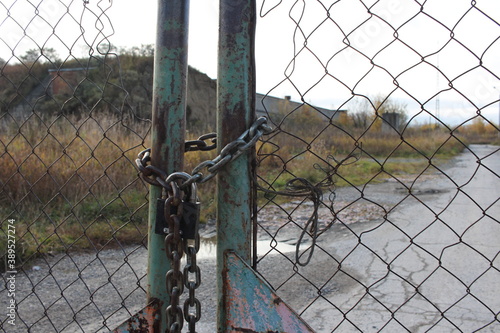 closed iron gates with a fence to the restricted area