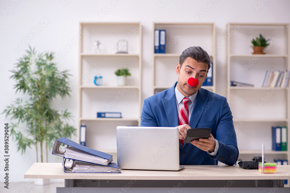 Funny employee clown working in the office Funny employee clown working in the office