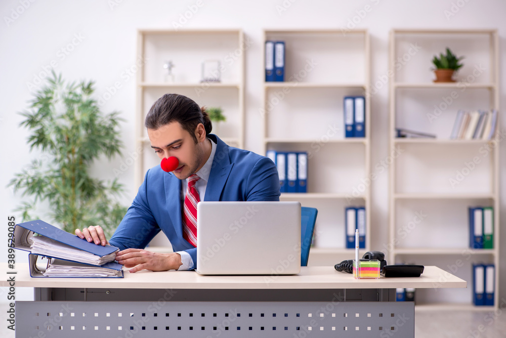 Funny employee clown working in the office Funny employee clown working in the office