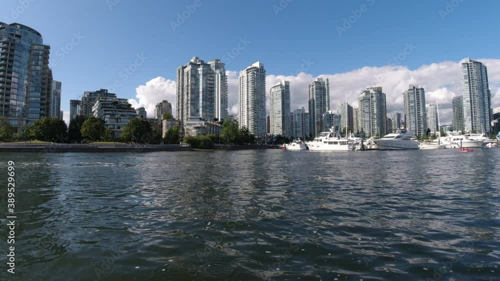 aerial fly over false creek with waves caused by motor boats pass by at an aquatic marina where yachts are parked in false creek yaletown next to the David Lam Park by the modern condominiums sunny3-3 aerial fly over false creek with waves caused by motor boats pass by at an aquatic marina where yachts are parked in false creek yaletown next to the David Lam Park by the modern condominiums sunny3-3