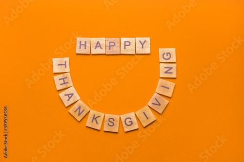 Inscription: "Happy thanksgivings" made of wooden blocks on a red background