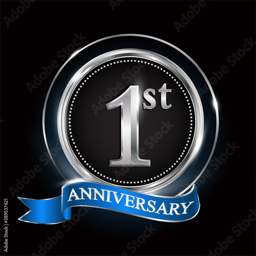 1st anniversary logo with silver ring and blue ribbon.