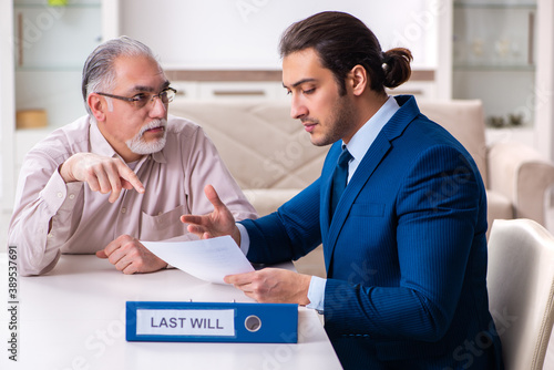 Young male lawyer visiting old man in testament concept