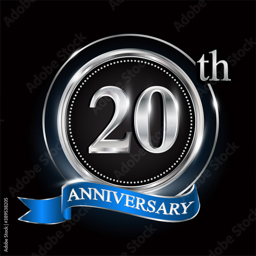 20th anniversary logo with silver ring and blue ribbon.